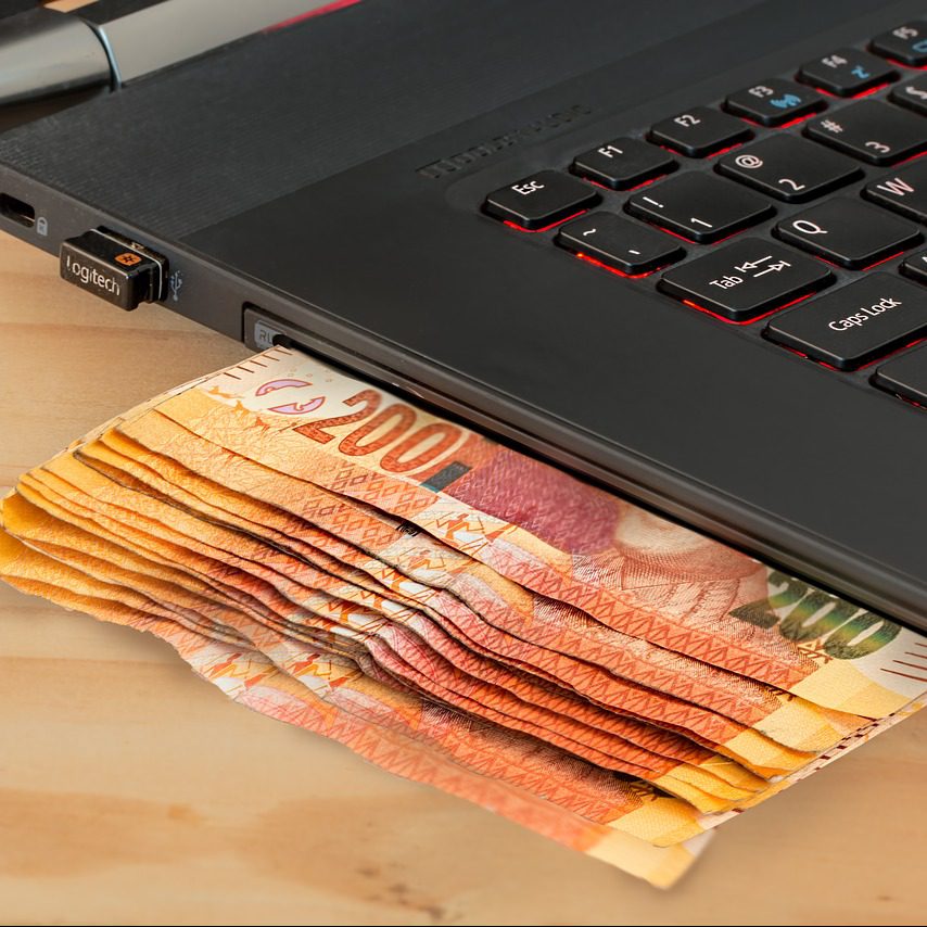 money coming out of a laptop