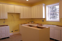 Kitchen with missing appliances. Remodeling in progress.