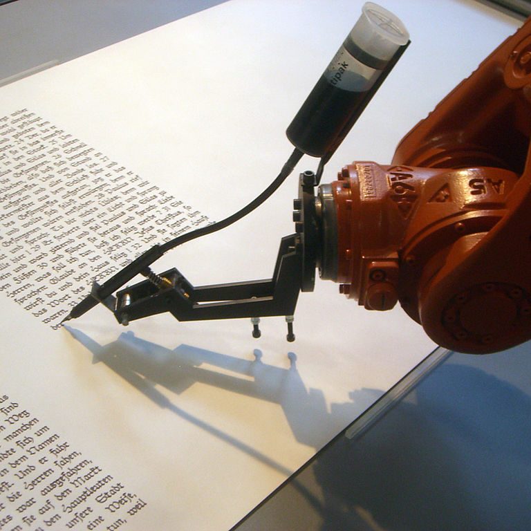 a robot arm writes on paper