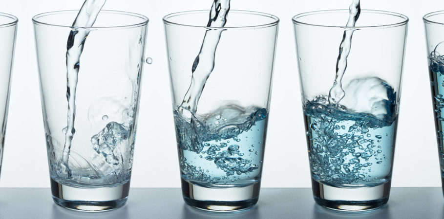 Glasses being filled up with water