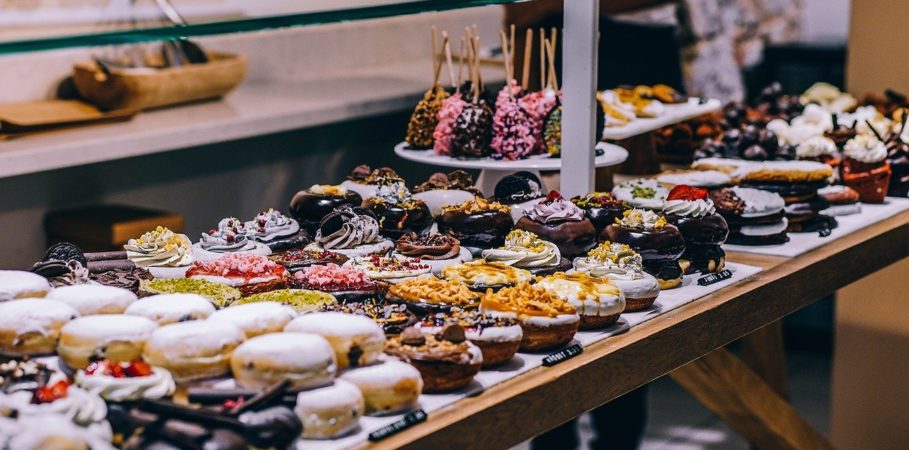 A display of different desserts like doughnuts, cupcakes, and cake pops