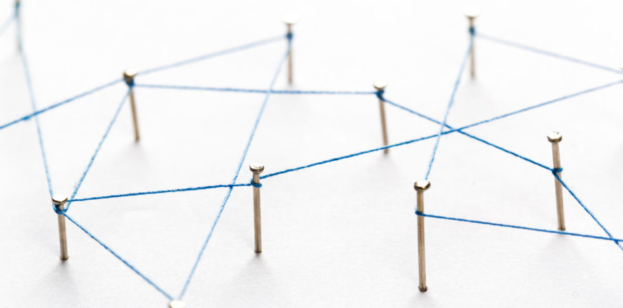 A large grid of pins connected with string. Communication, technology, network concept