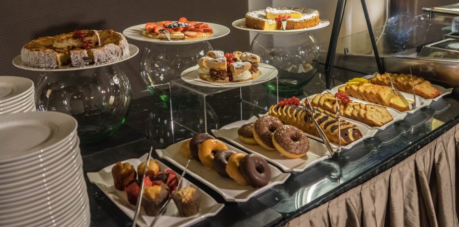 Breakfast buffet with different pastries and breads