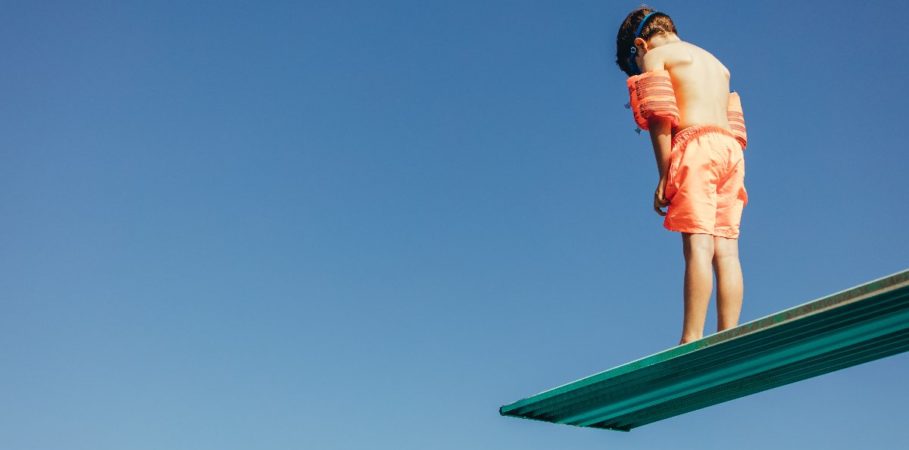 boy standing on diving board