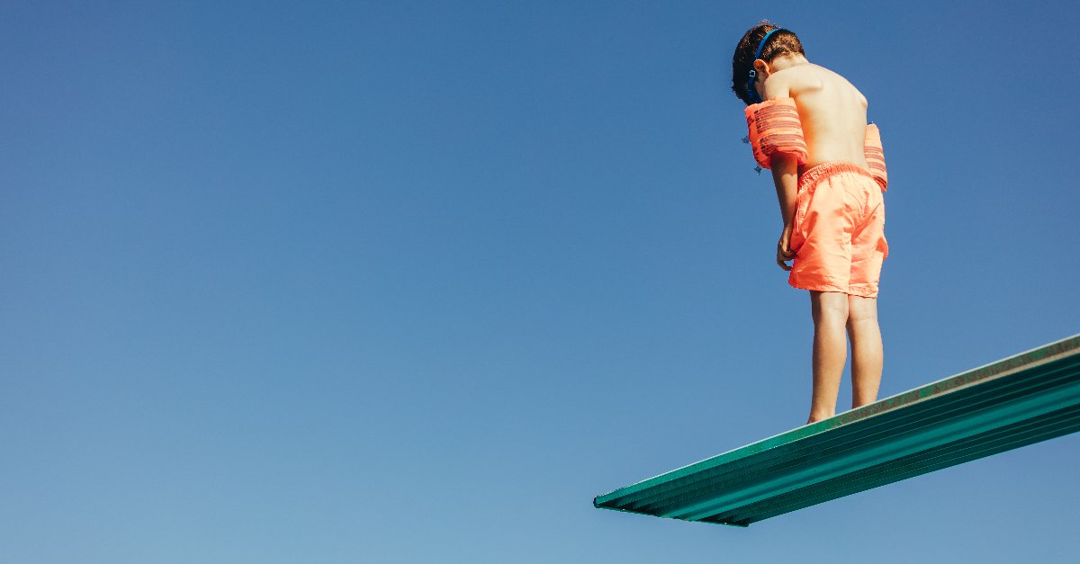 boy standing on diving board