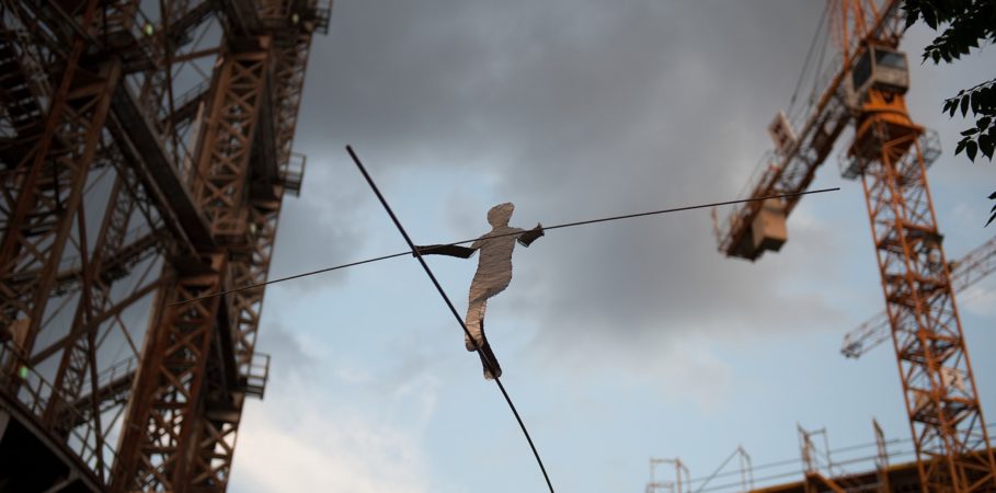 silhouetted figure on a tightrope