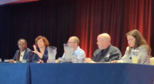 Panel of 5 people sitting at a blue table, Seated left to right, Dipo Ajose-Coker, Sarah O’Keefe, Scott Abel, Rob Hanna, and Megan Gilhooly.
