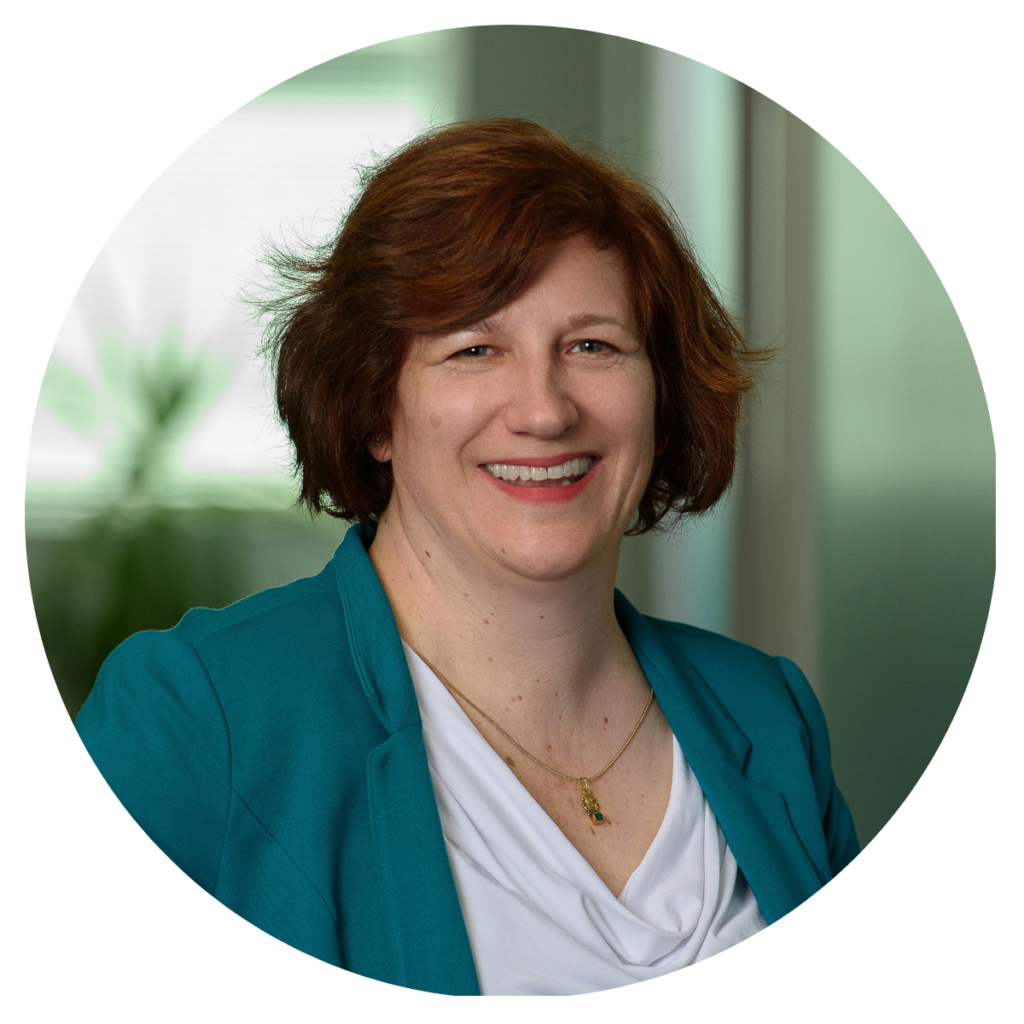Headshot of Sarah O'Keefe, white woman with short red/brown hair, white shirt and teal blazer
