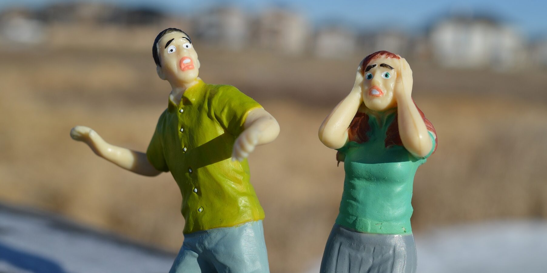 Miniature figures of a man and woman with fear on their faces
