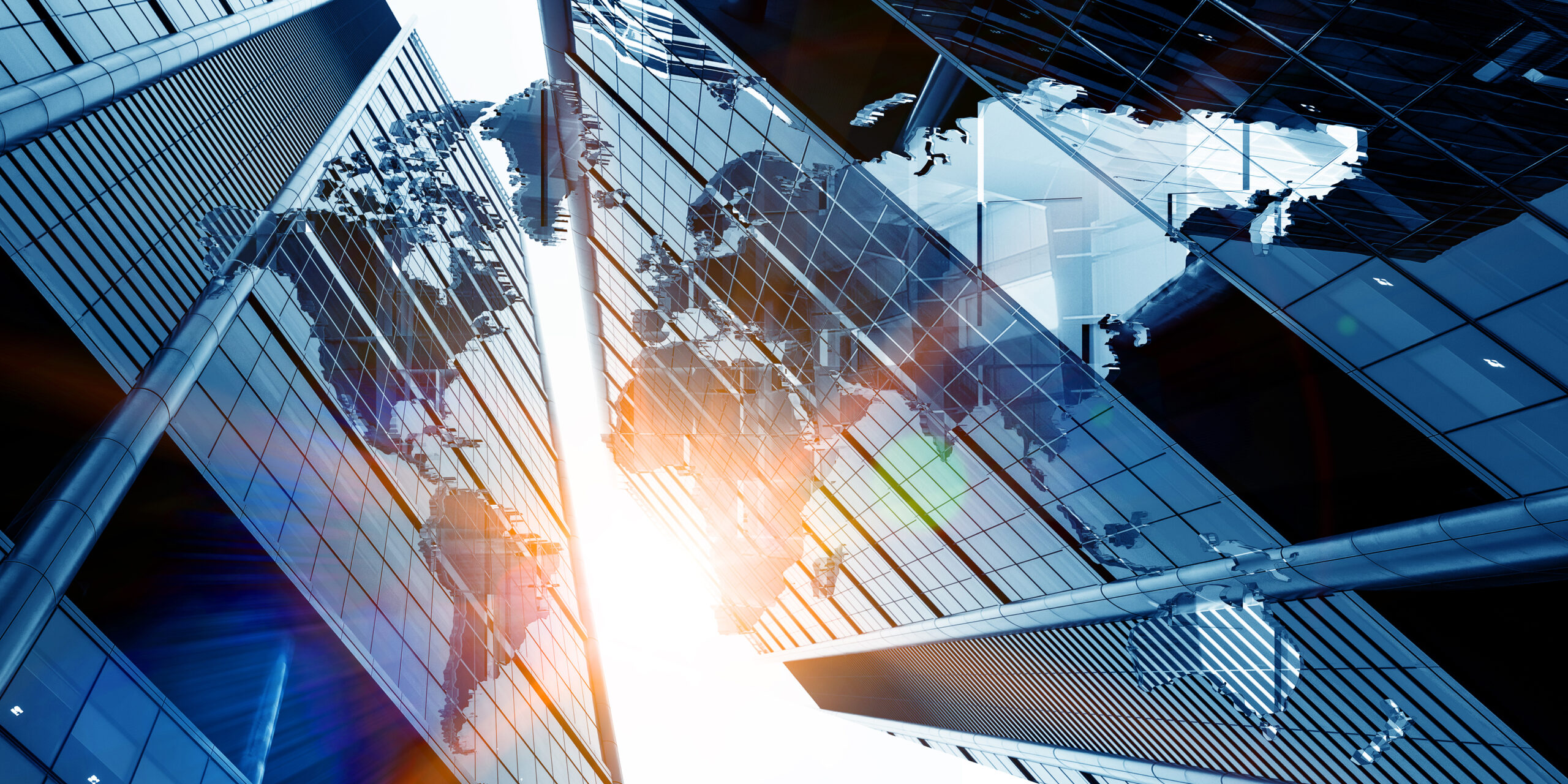 Upward view of tall glass skyscrapers reflecting sunlight, with a stylized world map overlaid across the building surfaces, creating a global business or international connectivity theme.