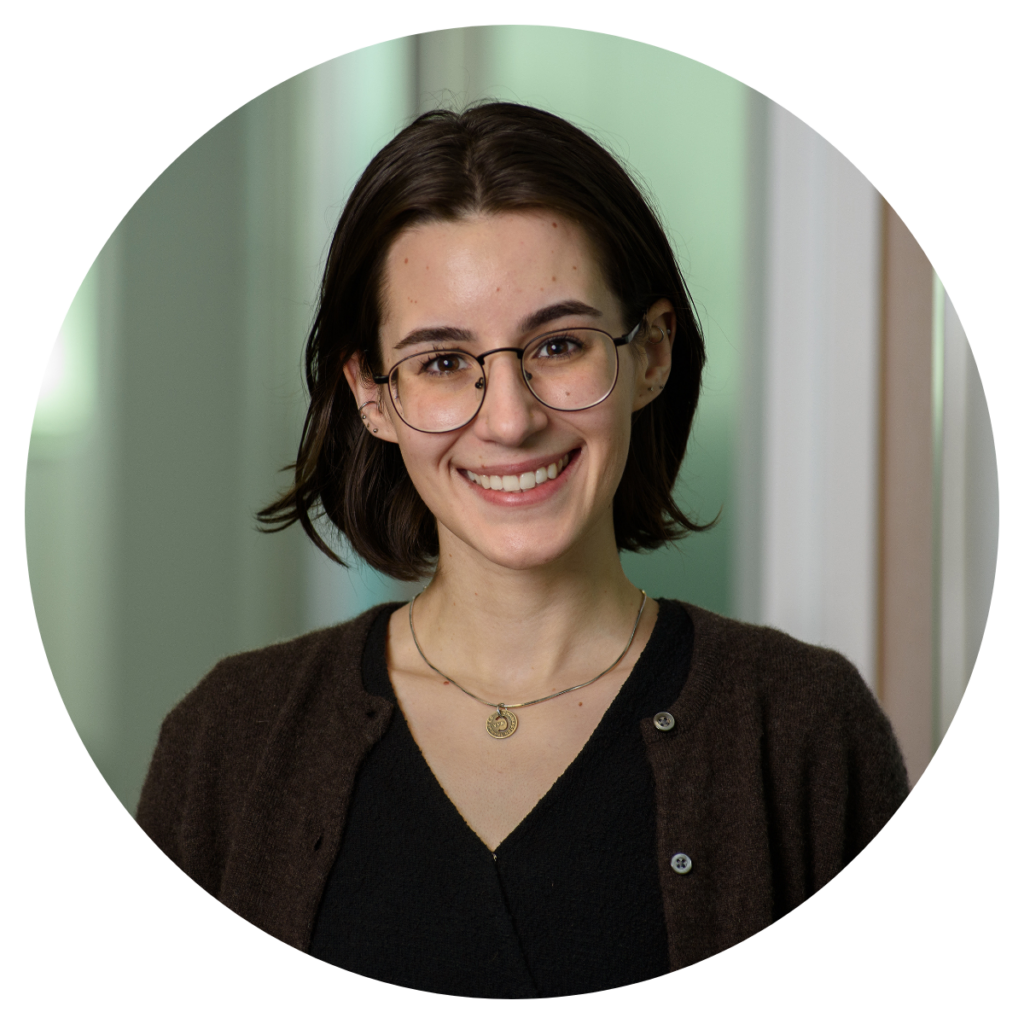 Headshot of Allison Beatty, woman with short dark brown hair with dark shirt and dark red cardigan.